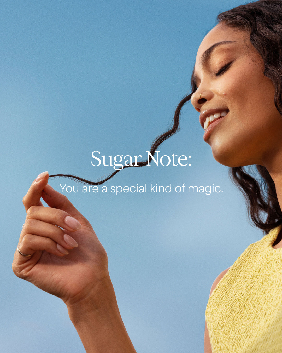 Woman holding a sugar note against a blue sky with text 'You are a special kind of magic.'