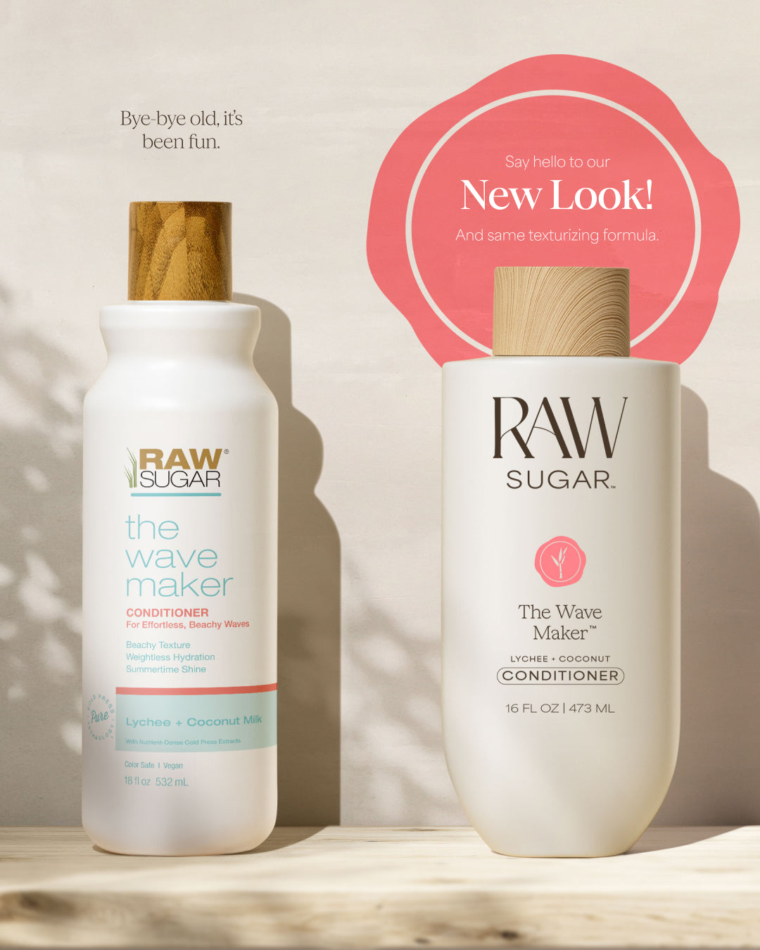 Two bottles of Raw Sugar hair care products on a wooden surface with a pink circle indicating a new look.