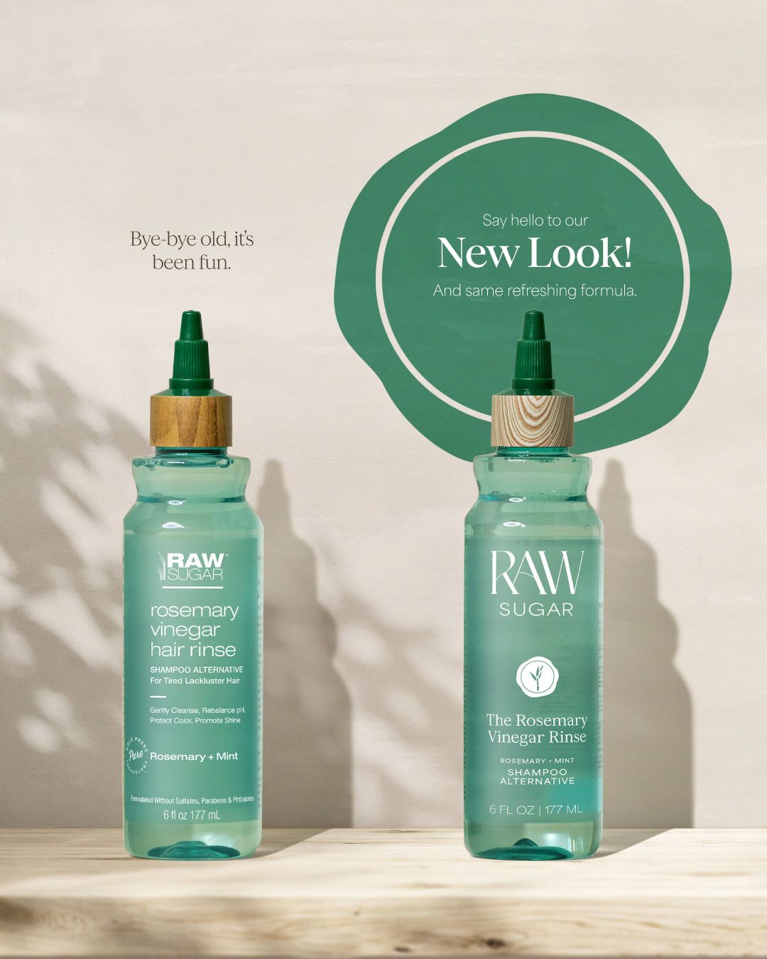 Two bottles of RAW Sugar Rosemary Vinegar Hair Rinse on a wooden surface with a light background.