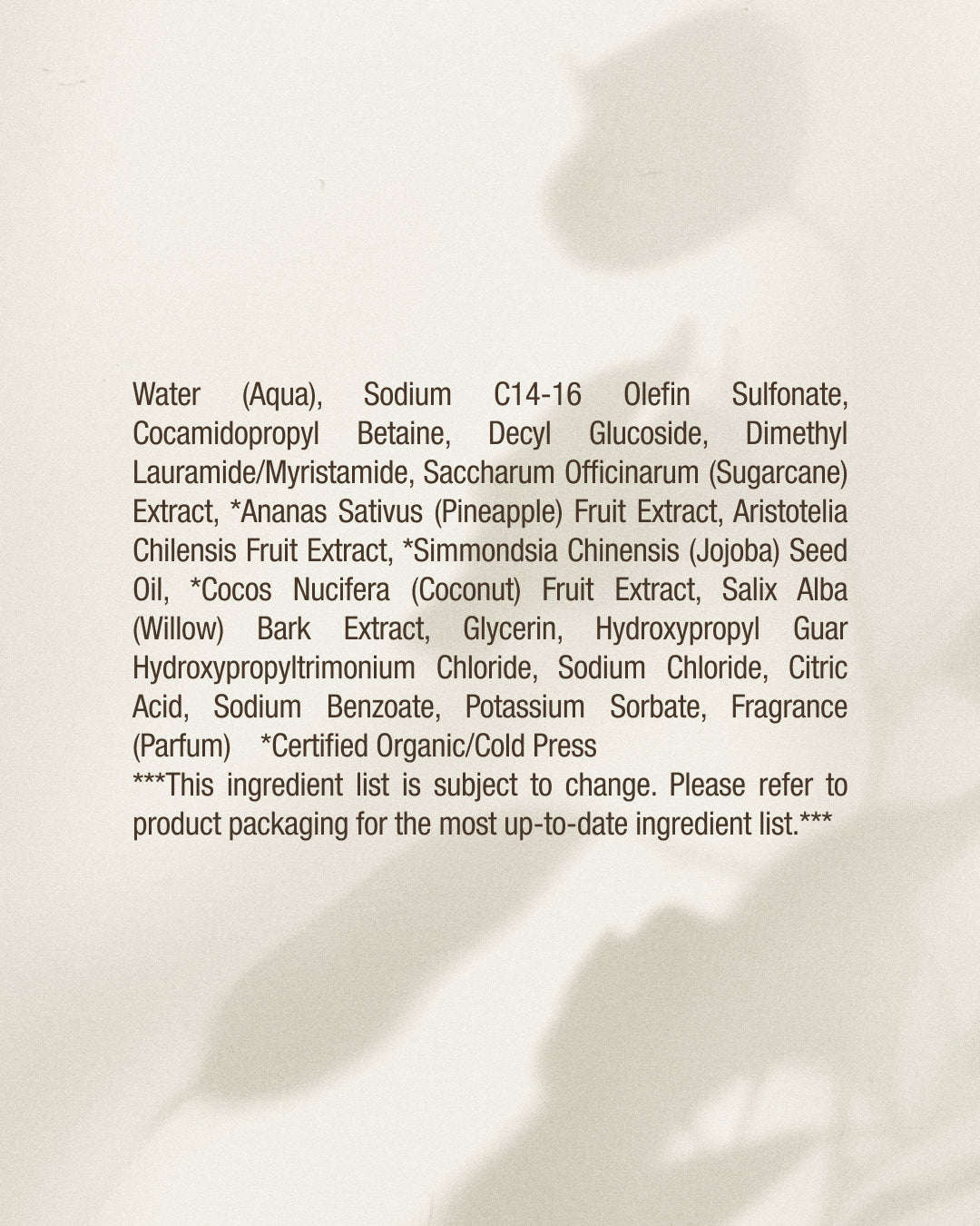 Ingredients list on a beige background with a soft focus for Raw Sugar Body Wash designed to help gently cleanse and hydrate skin with clean ingredients.