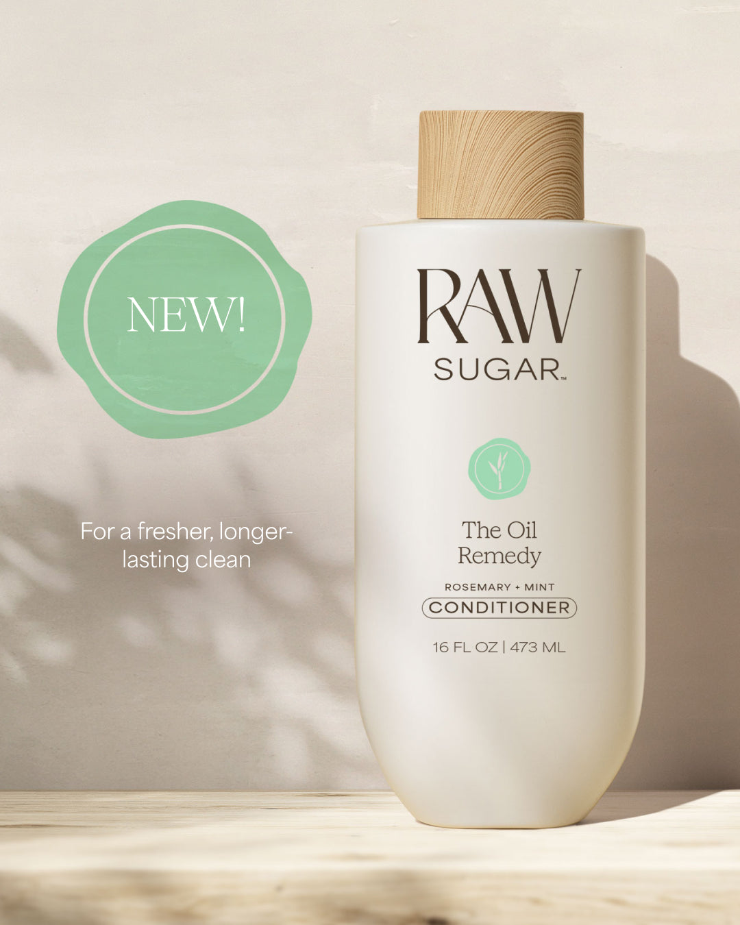 RAW SUGAR conditioner bottle with a wooden cap on a light background, designed to help balance oil in hair with clean ingredients.
