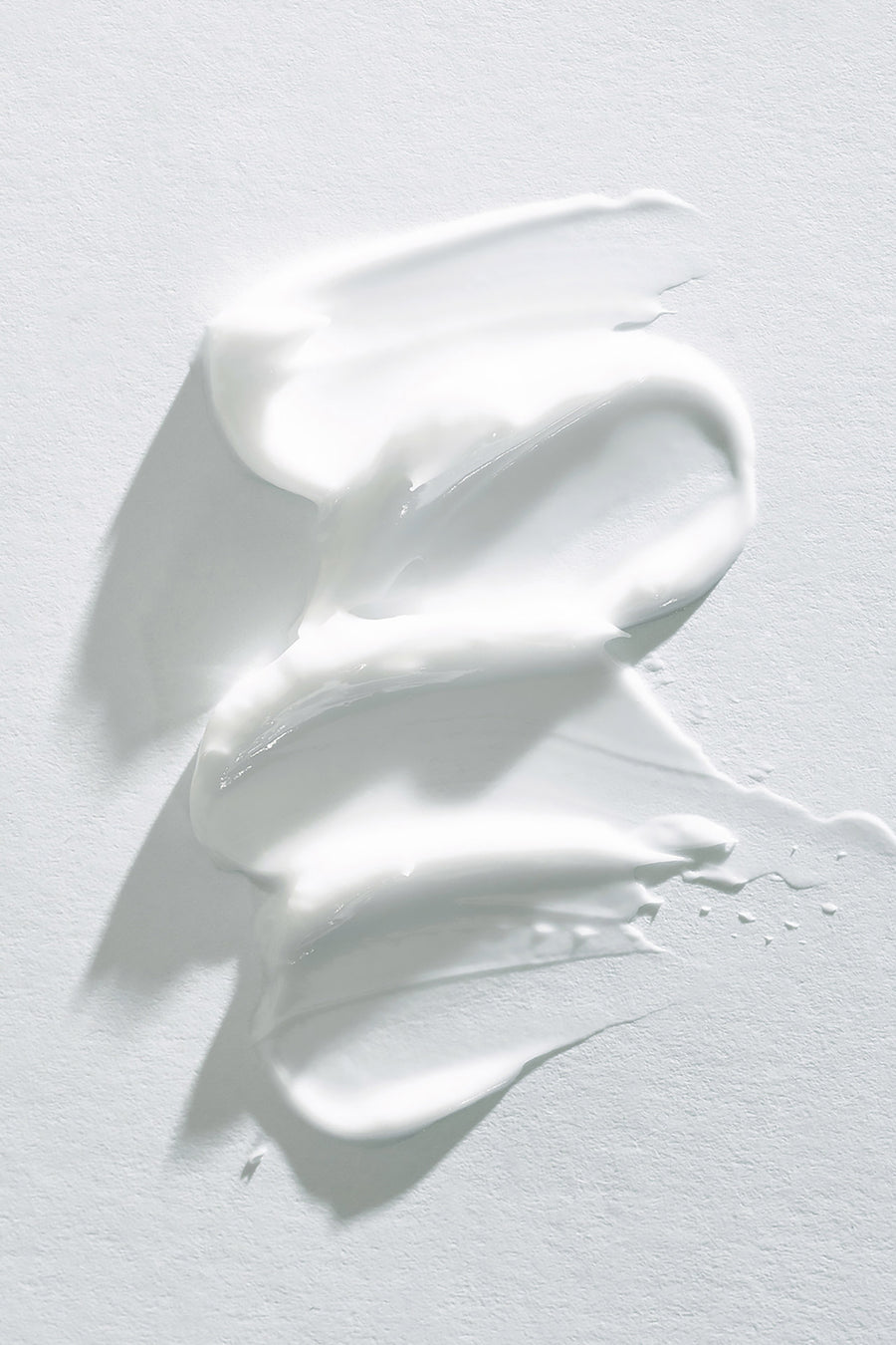 goop image of lotion smeared on white background