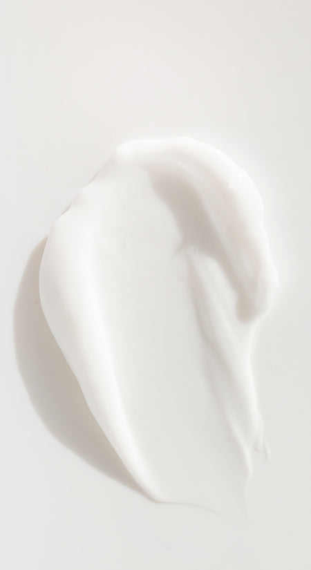 goop image of lotion smeared on white background
