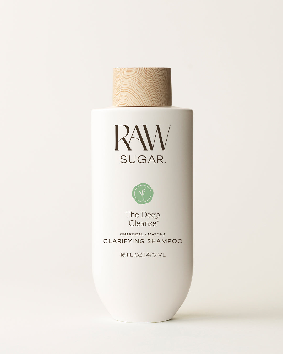 Bottle of Raw Sugar Deep Cleanse Shampoo on a cream background, designed to help cleanse hair with clean ingredients.