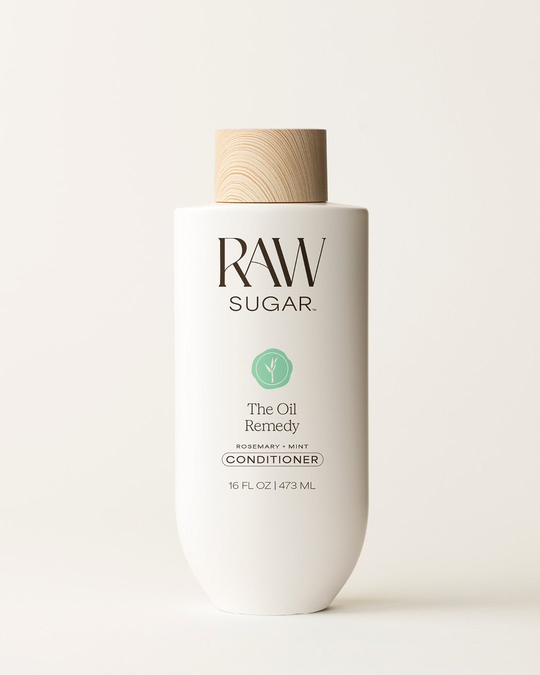 Bottle of Raw Sugar Oil Remedy Conditioner on a cream background, designed to help balance oil in hair with clean ingredients.