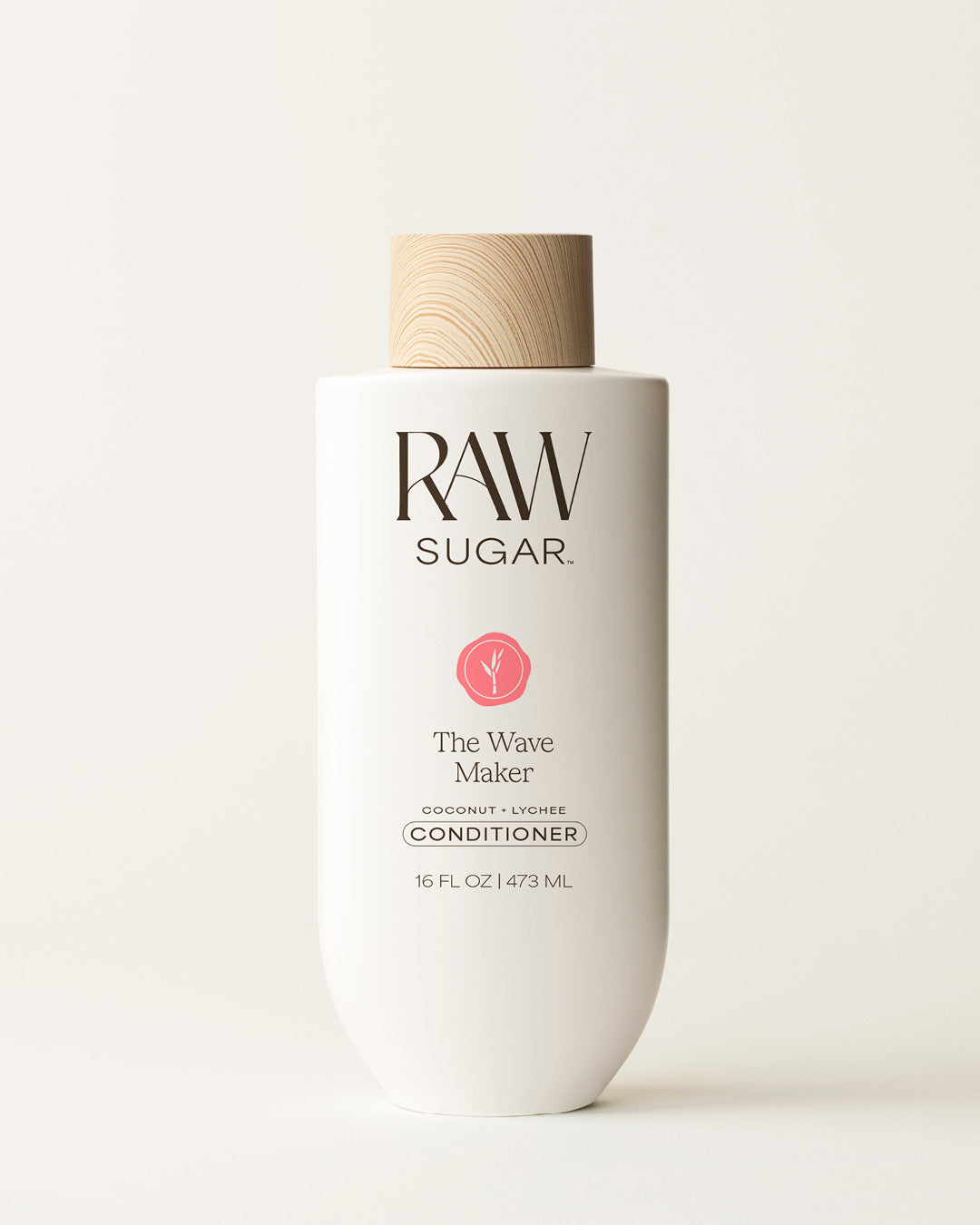 Bottle of Raw Sugar Wave Maker Conditioner on a cream background, designed to help nourish hair with clean ingredients.