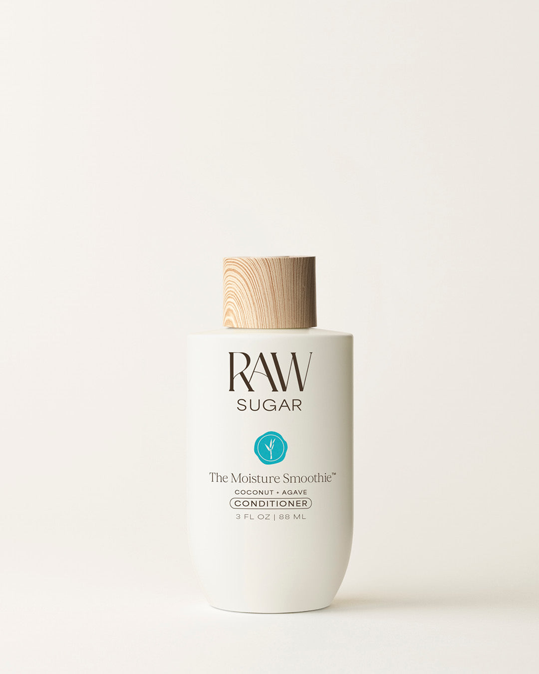 Travel Bottle of Raw Sugar Moisturizing Conditioner on a cream background, designed to help moisturize hair with clean ingredients.