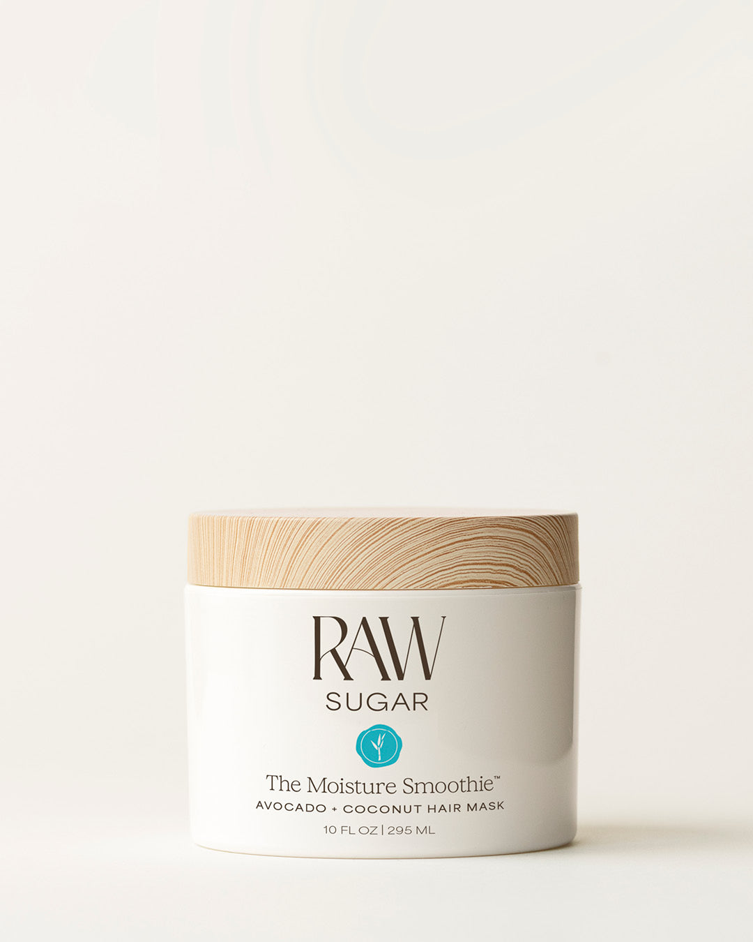 Bottle of Raw Sugar Moisturizing Mask on a cream background, designed to help moisturize hair with clean ingredients.