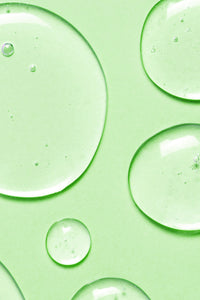 body wash drops on green background