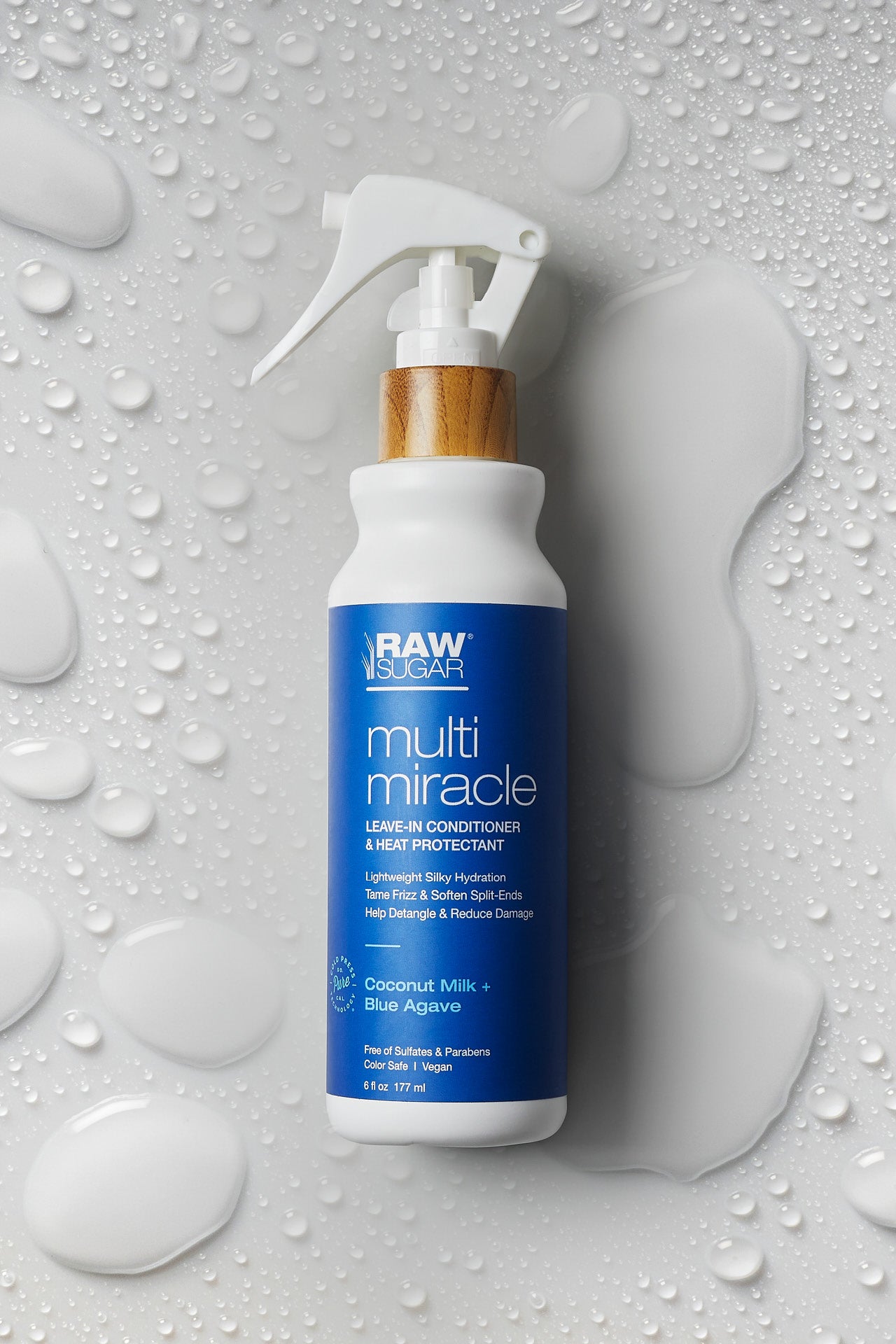 multi miracle leave in conditioner laying on ground with water droplets