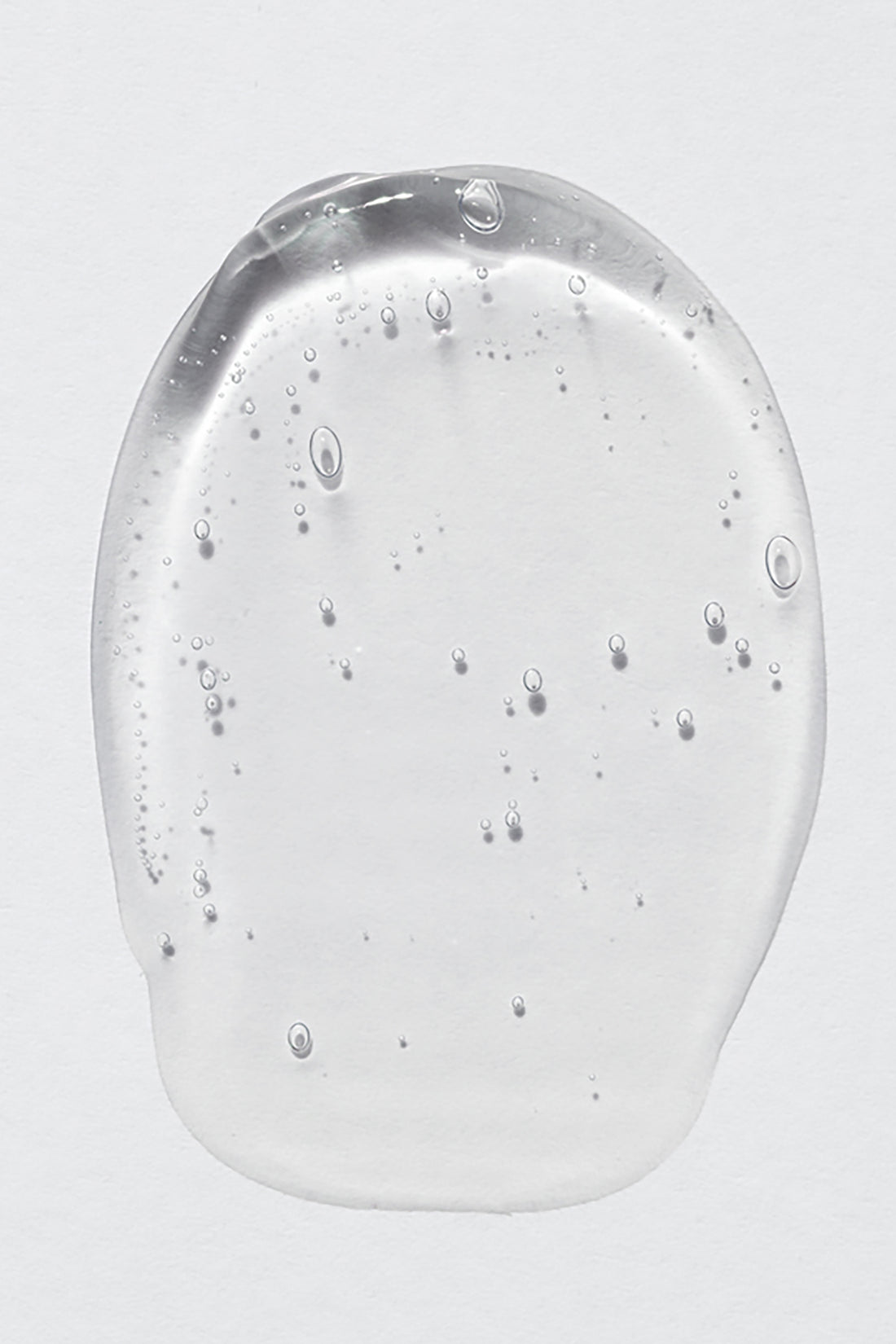 drop of body wash on light grey background