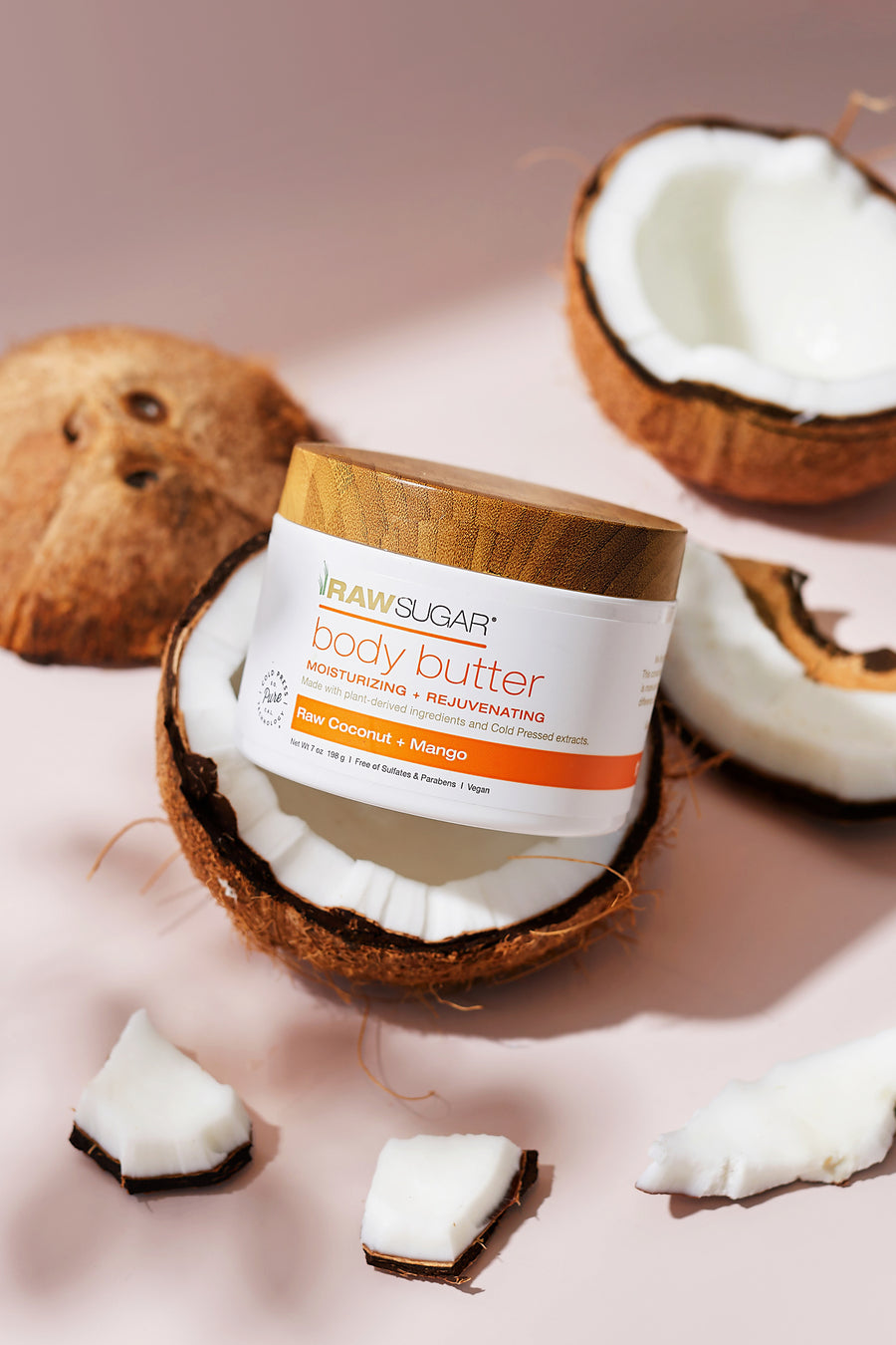 mango body butter sitting in coconuts