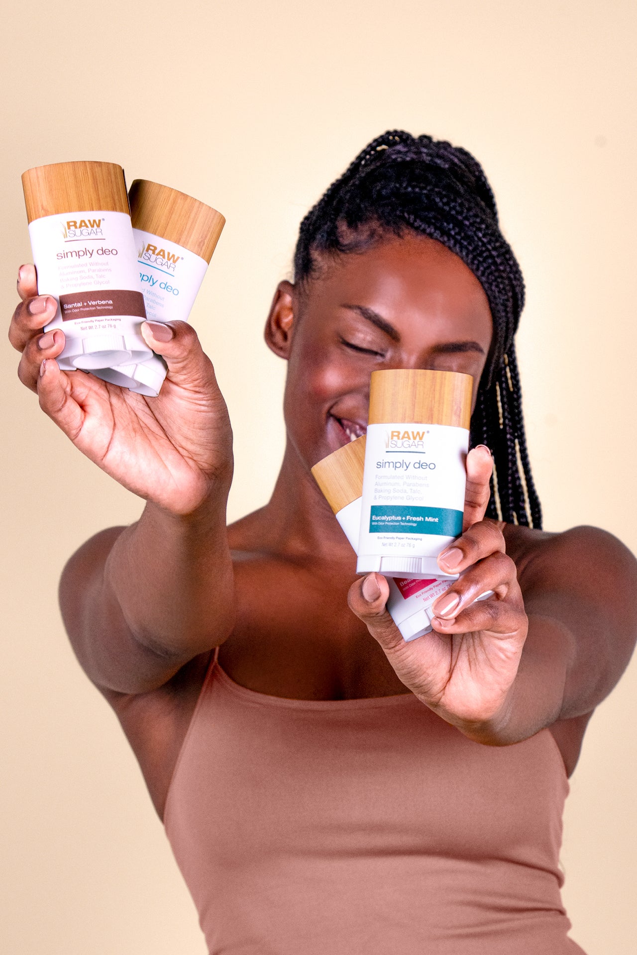 woman holding multiple aluminum free deodorants