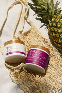 body butter and scrub next to pineapple