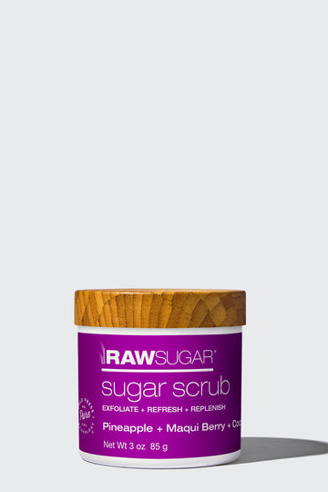 3 oz pineapple sugar scrub in front of white background, cold press ingredients