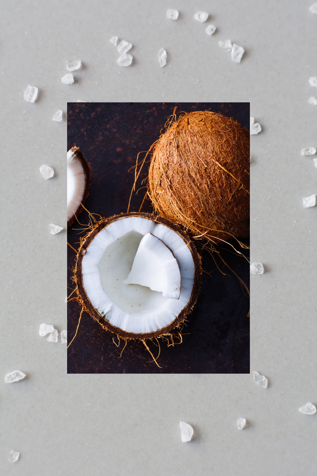 half of coconut in front of sea salt flakes