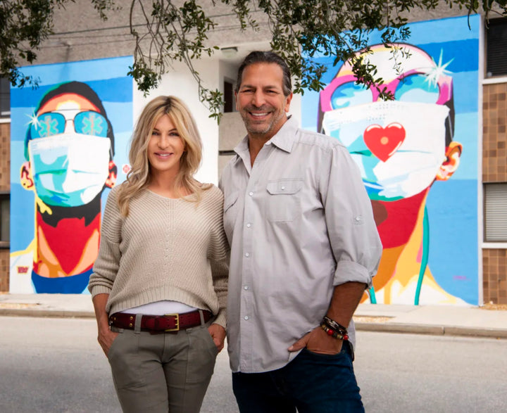 ronnie and donda in front of mural