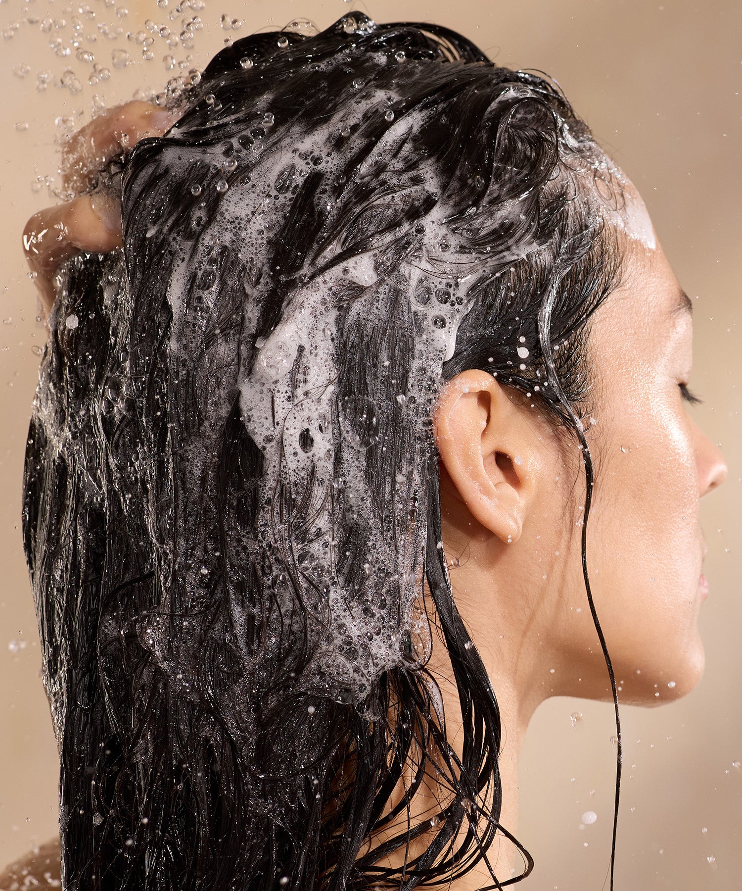 shop all Raw Sugar hair care, woman washing hair