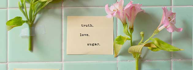 truth love sugar sticky note on tile with flowers next to it