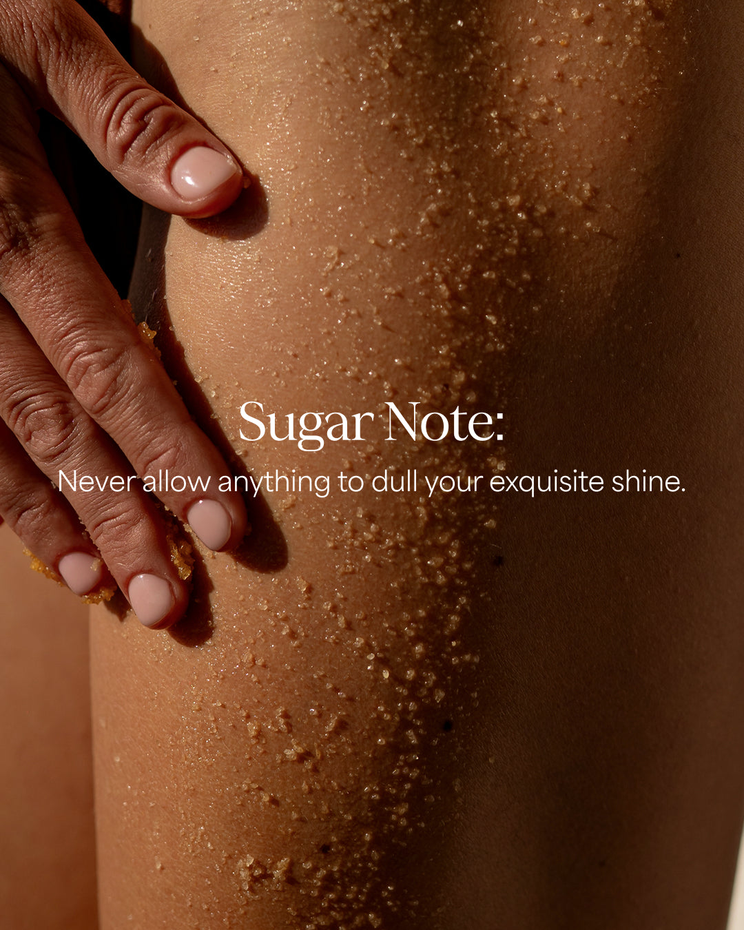 Close-up of a person's leg and hand covered with coarse sugar crystals, with overlaid text reading 'Sugar Note: Never allow anything to dull your exquisite shine.'.