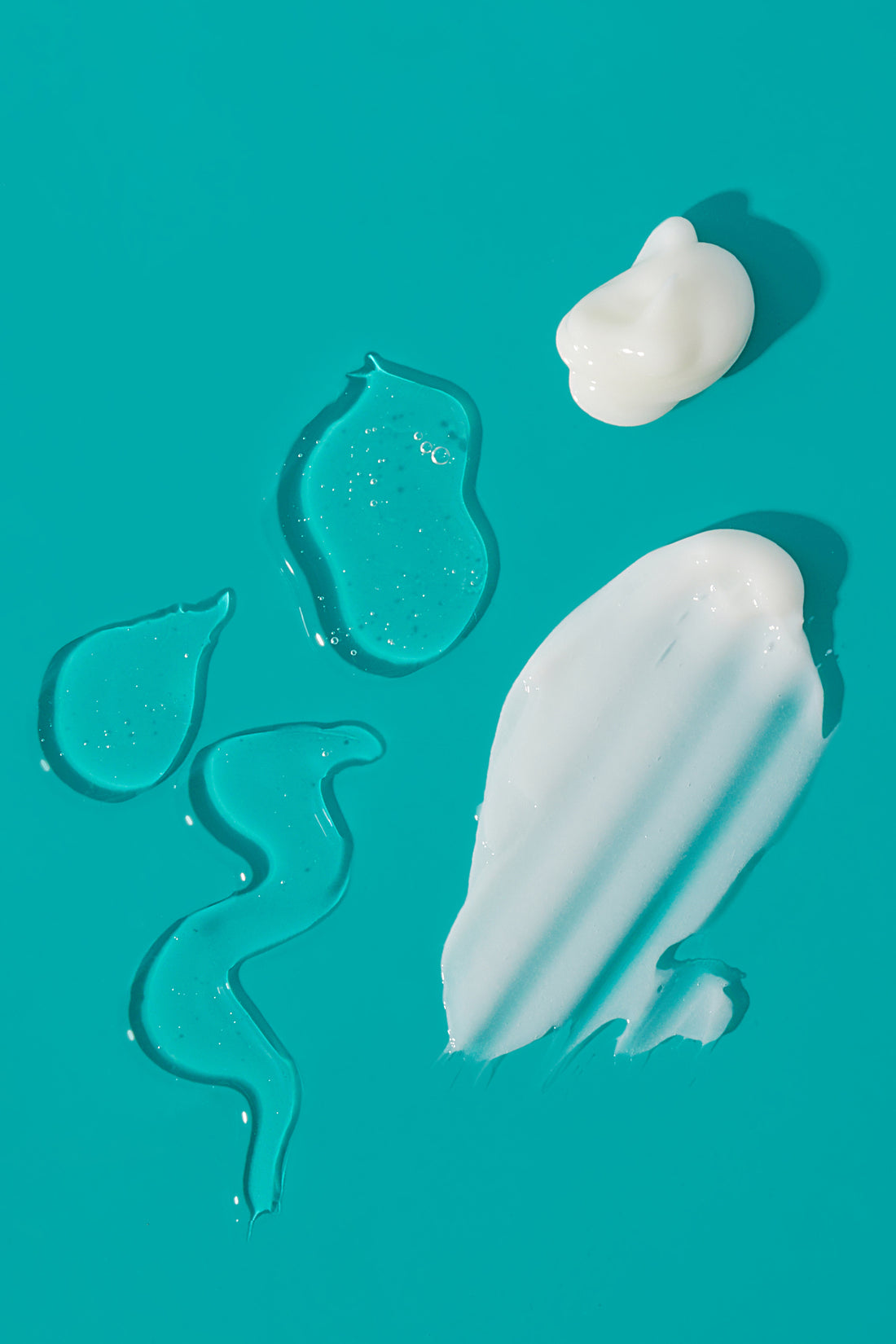 shampoo and conditioner goop on teal background