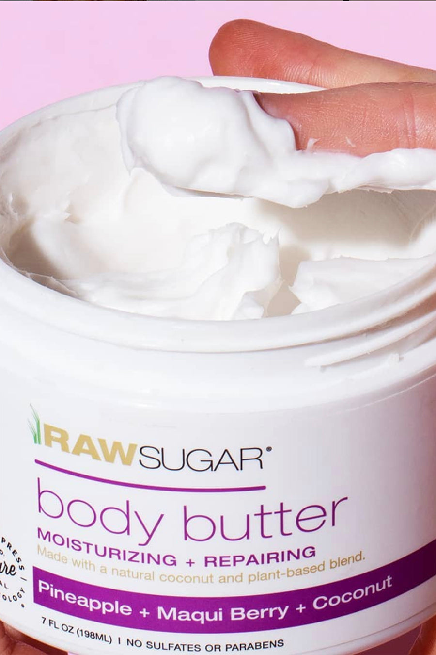 jar of body butter with finger covered with lotion