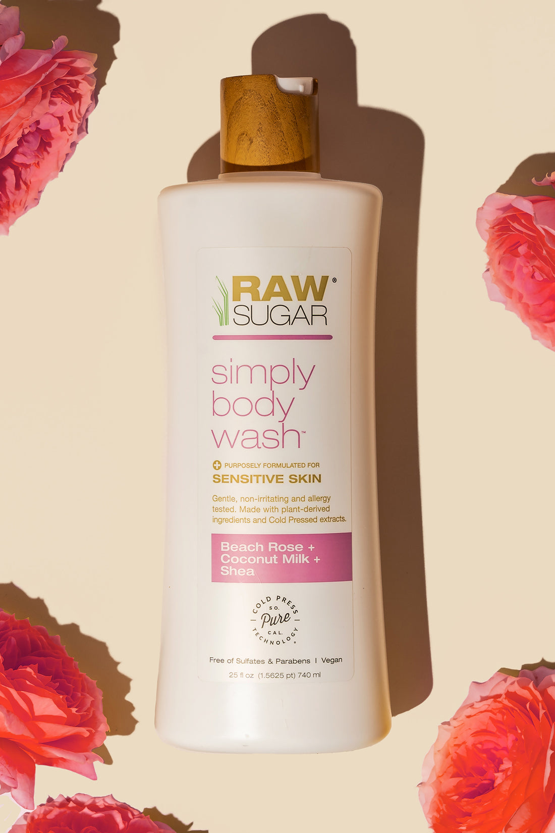 Bottle ofSimply Body Wash for Sensitive Skin | Beach Rose + Coconut Milk + Shea lying next to roses