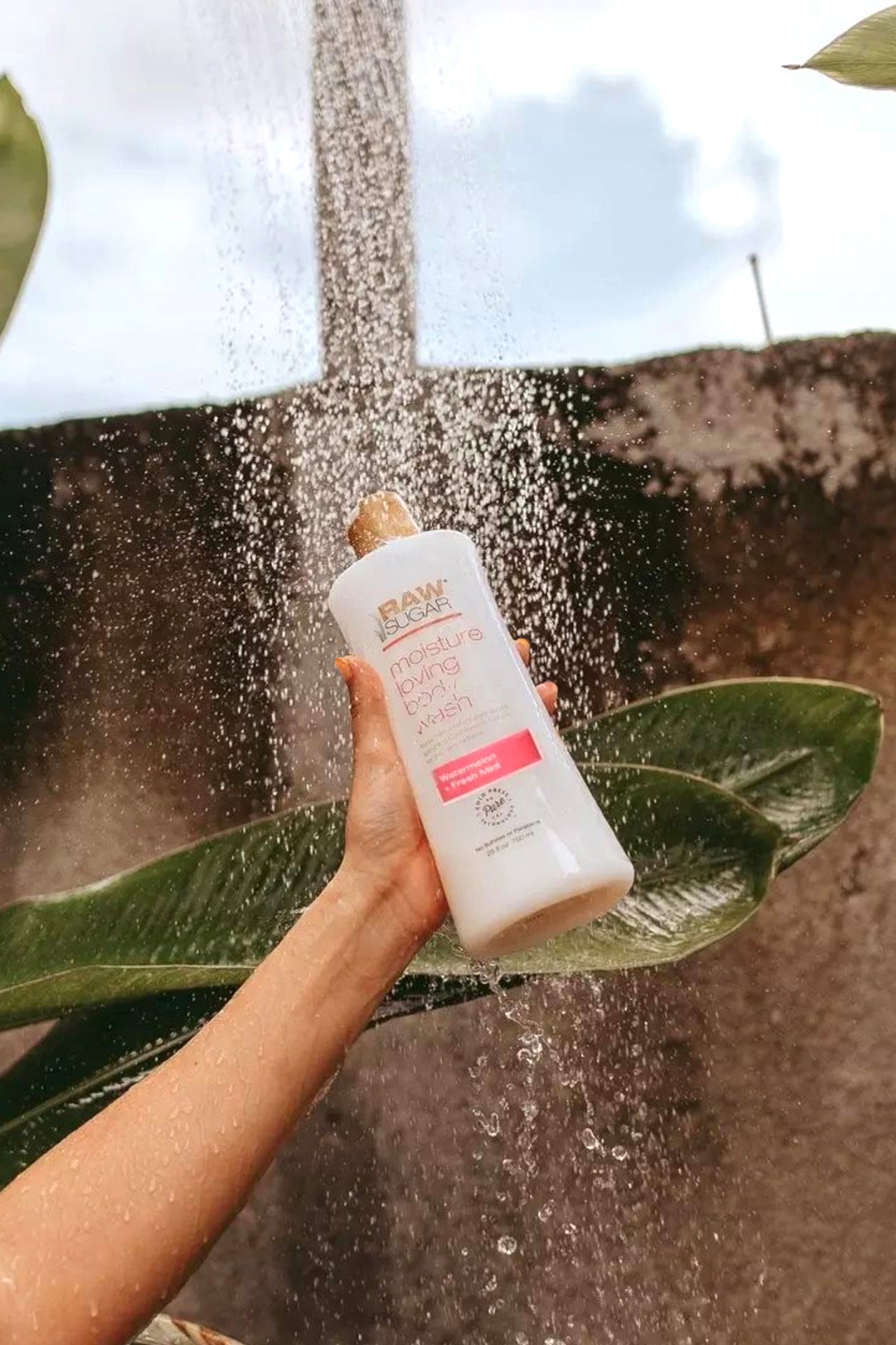 Hand Holding Body Wash Under Waterfall