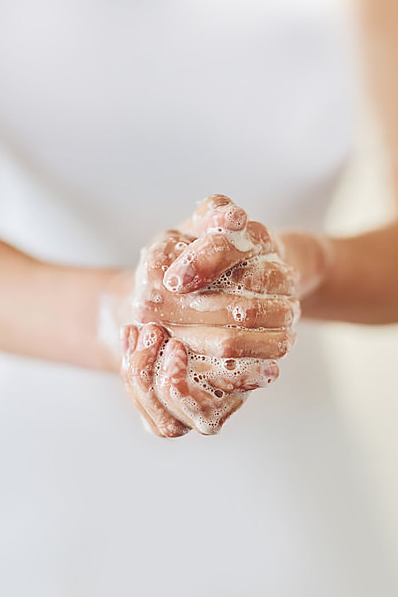 A clasped pair of hands lathering up during washing