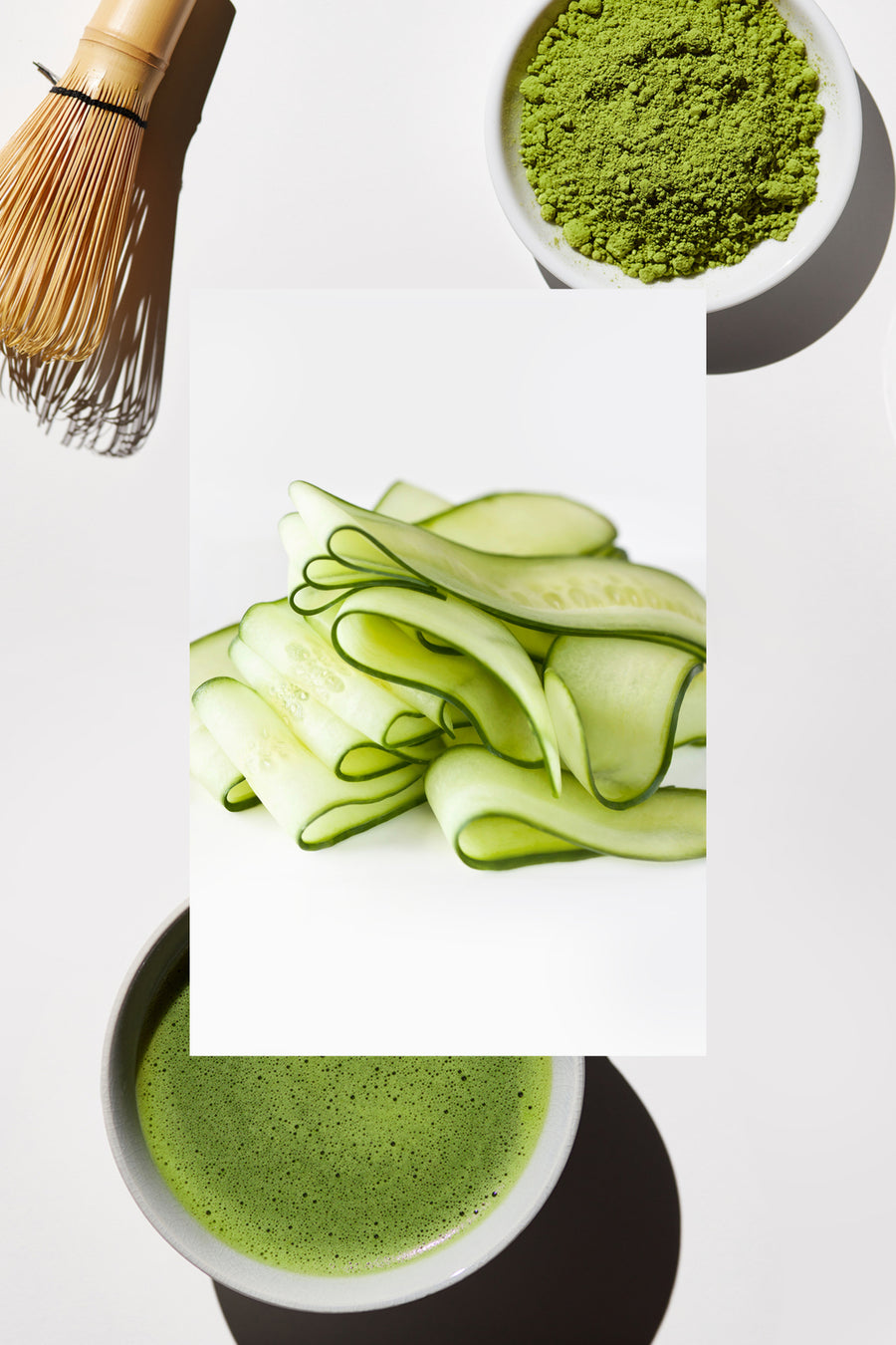 image of green tea and matcha whisk with cucumber in front