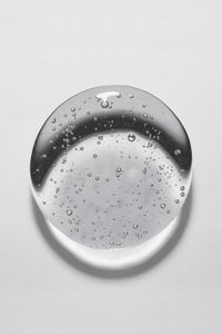 large drop of clear water with bubbles