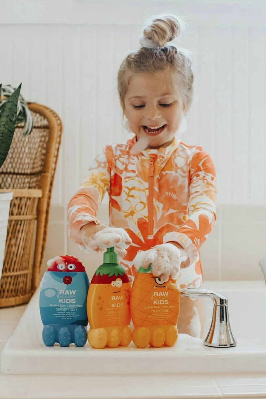 girl standing in bath tub playing with raw sugar kids products