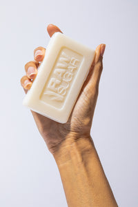 Hand Holding Soap with Raw Sugar Logo