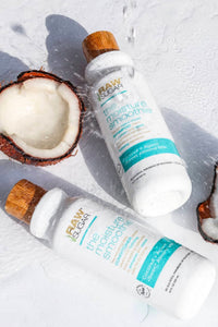 Raw Sugar Moisture Smoothie Shampoo and Conditioner next to each with open coconut and water pouring over it