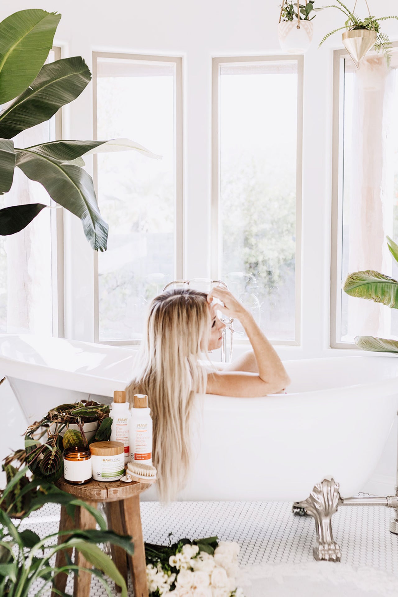 Woman in Bath tub with Products on a Stool