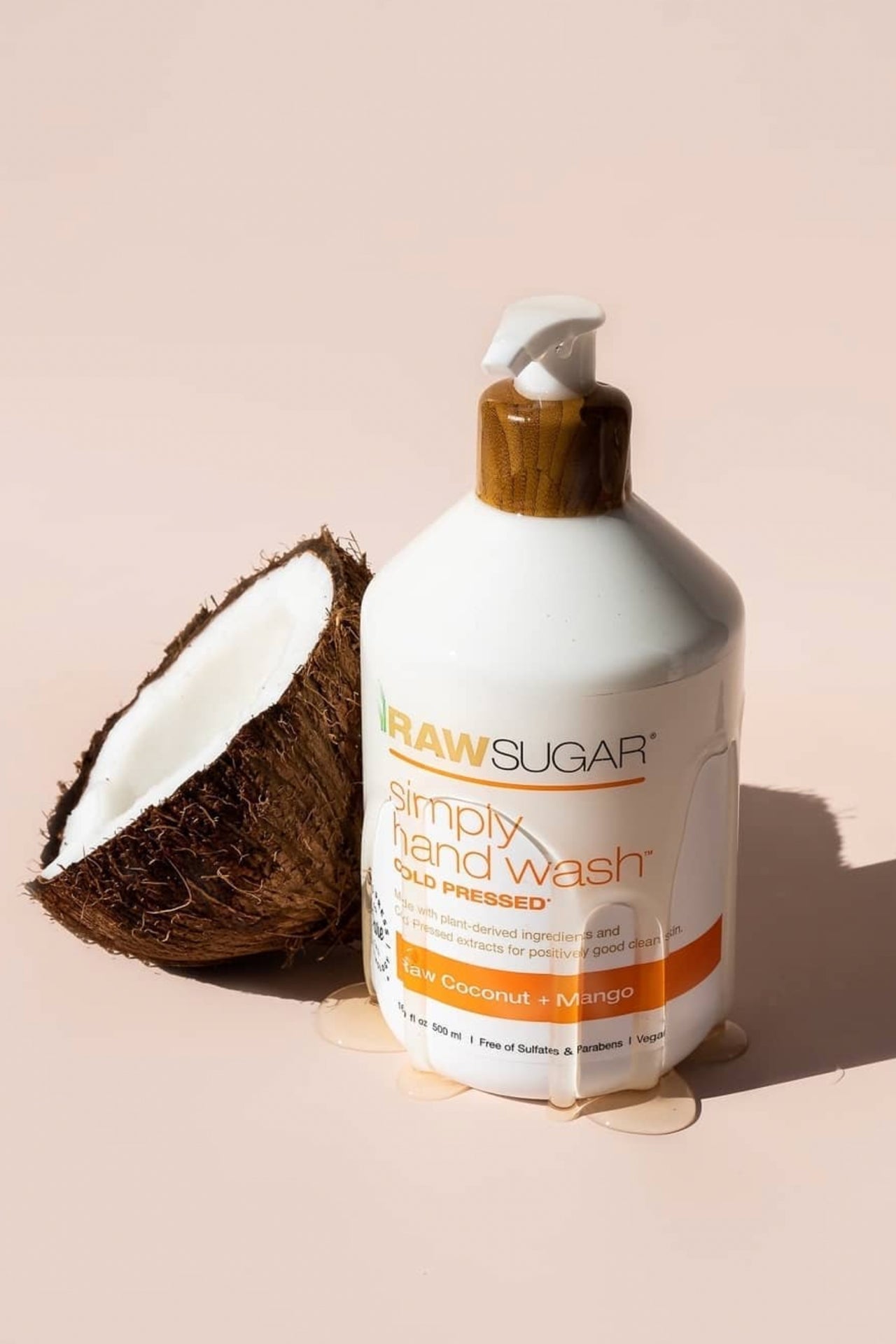 Raw Sugar Hand Wash overflowing next to raw coconut