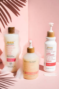 group shot of Raw Sugar Watermelon Body Wash, Hand Wash, and Lotion on pink background with palm leaf shadow