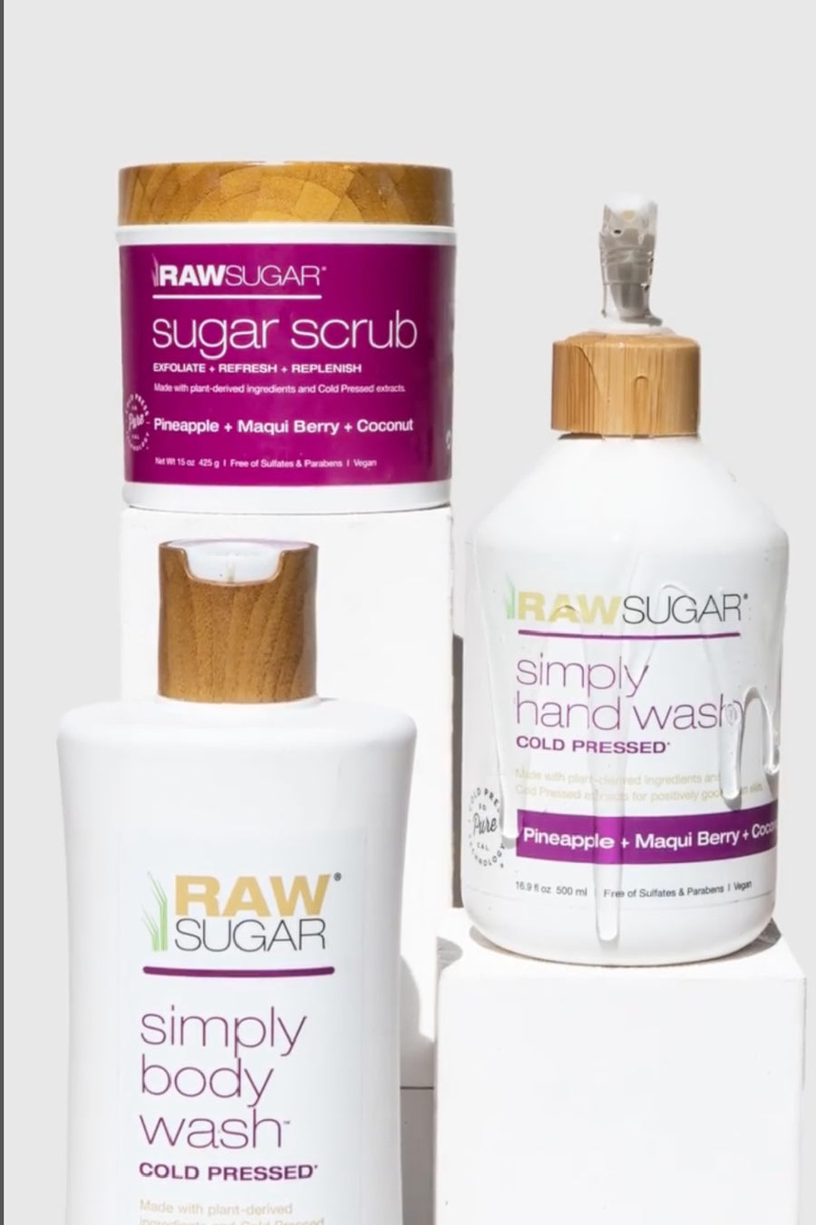 Raw Sugar body products stacked next to each other, including Sugar Scrub, Hand Wash, Body Wash 