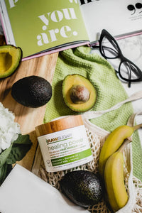 Raw Sugar Hair Masque next to magazine fruit and glasses