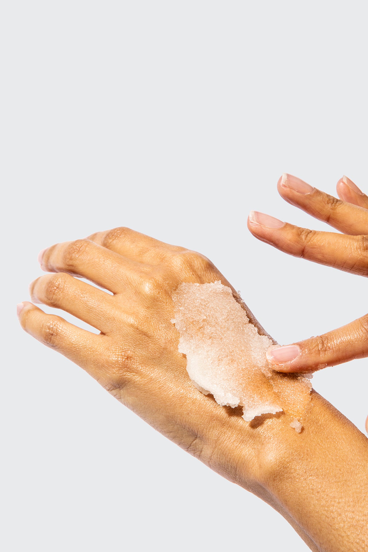 Hand with Raw Sugar Sugar Scrub on it.