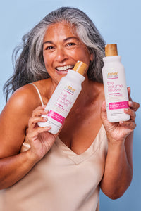 woman holding volume revive shampoo and conditioner