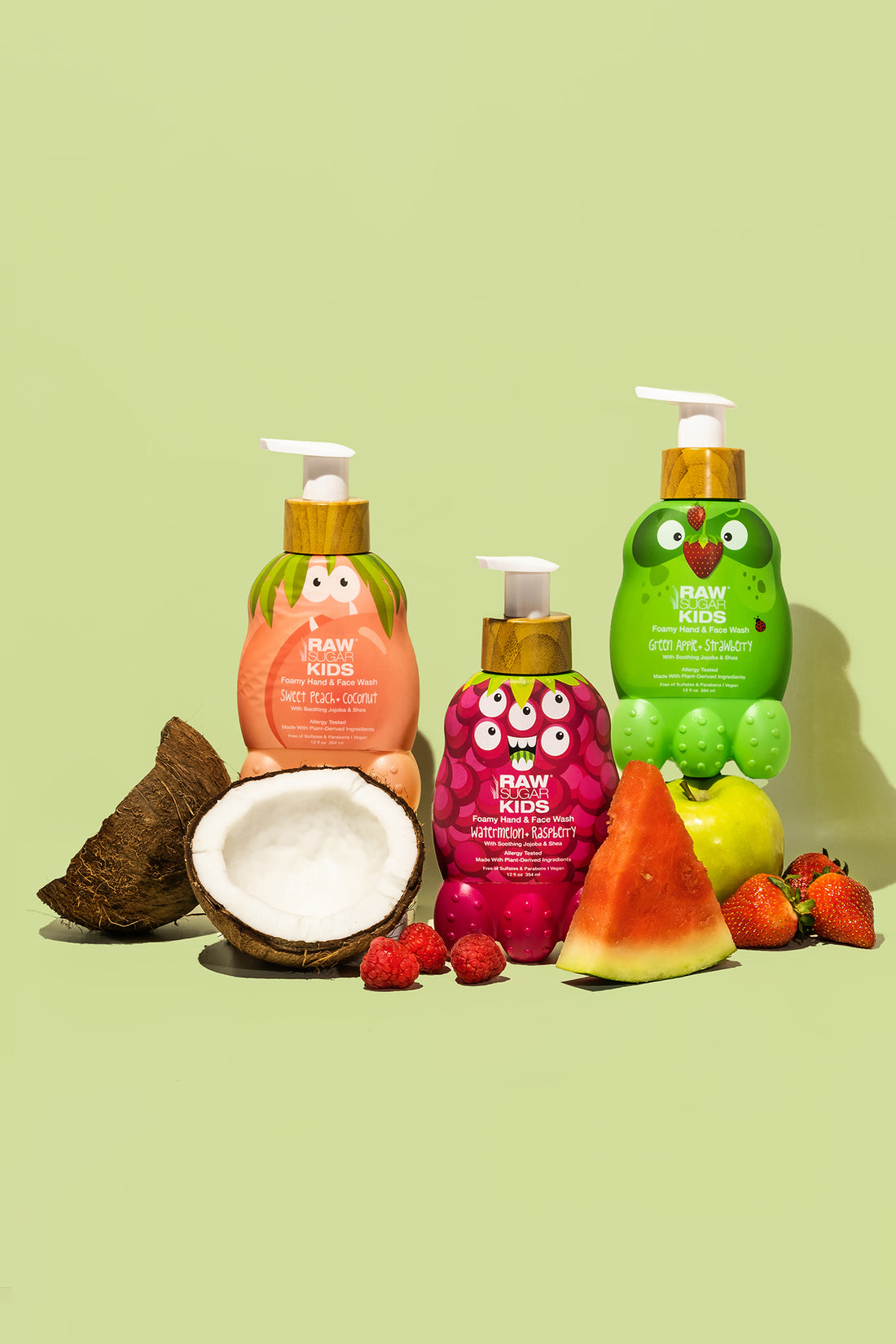 All 3 Raw Sugar Kids Face Foamy Hand + Face Washes with halved Raw Coconut, fresh strawberries. green apple and watermelon