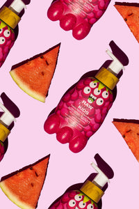 Raw Sugar Kids' Foamy Hand + Face Wash | Watermelon + Raspberry lying amongst fresh triangle watermelon slices