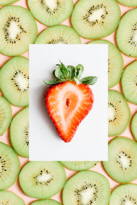 A single sliced fresh strawberry with Kiwi slices