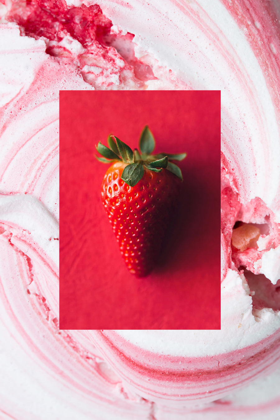 A single whole fresh strawberry on red background with strawberry cream swirl