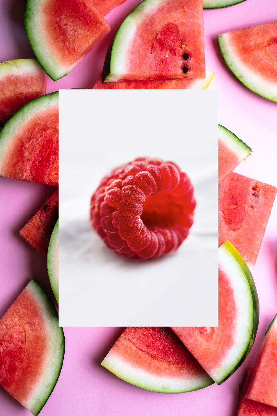 A single fresh raspberry with fresh watermelon slices