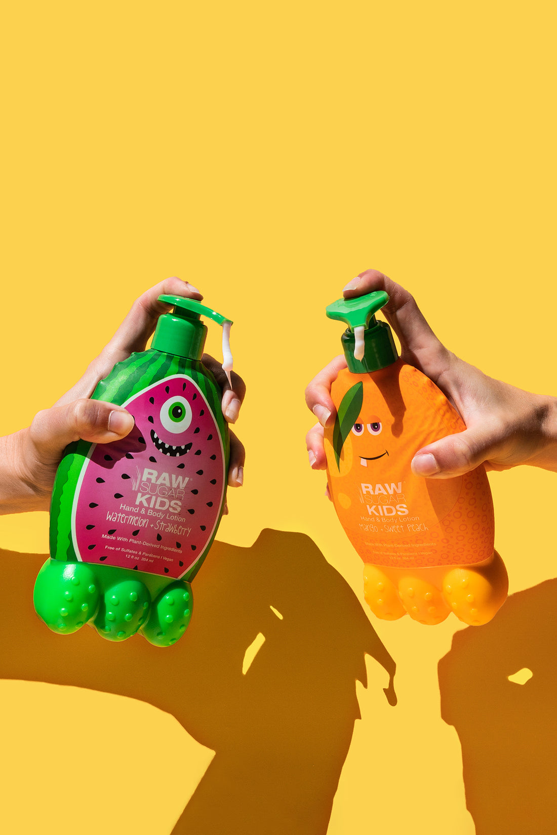 Hands Holding Kids Lotions in front of orange background