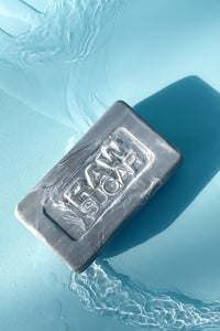 image of bar soap on a blue background with water